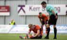 Kai Fotheringham nurses a slight thigh strain during Dundee United's clash against Falkirk