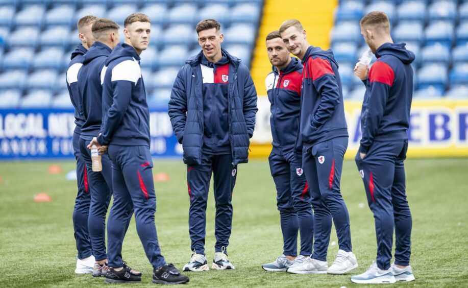 Raith Rovers players stand in a huddle on Kilmarnock's Rugby Park pitch.