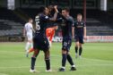 Zach Robinson celebrates with Diego Pineda as Dundee beat Dumbarton. Image: SNS
