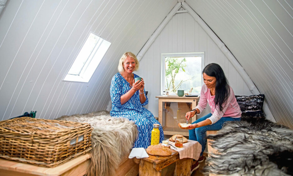 Charlotte Blackler runs bee therapy sessions in an apipod at Monachyle Mhor. Here, she and Gayle Ritchie enjoys some bread and honey as part of the experience. Picture: Kenny Smith.