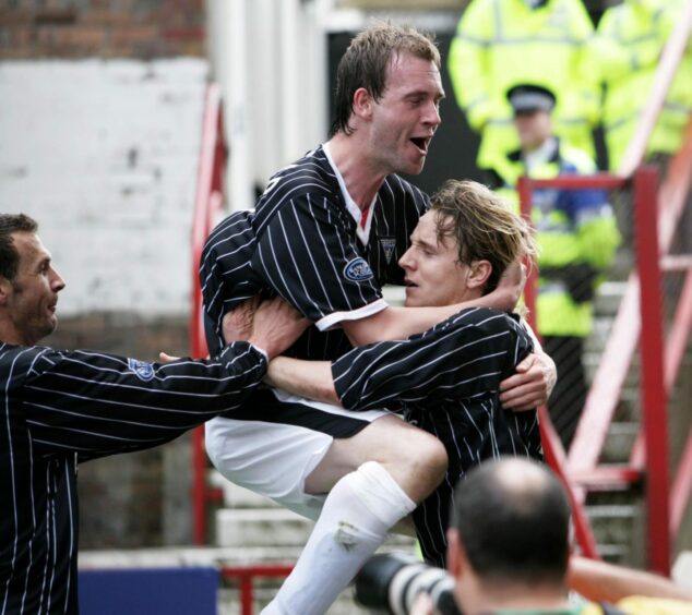 Jamie McCunnie playing for Dunfermline congratulates Tam McManus for a goal against Dundee United