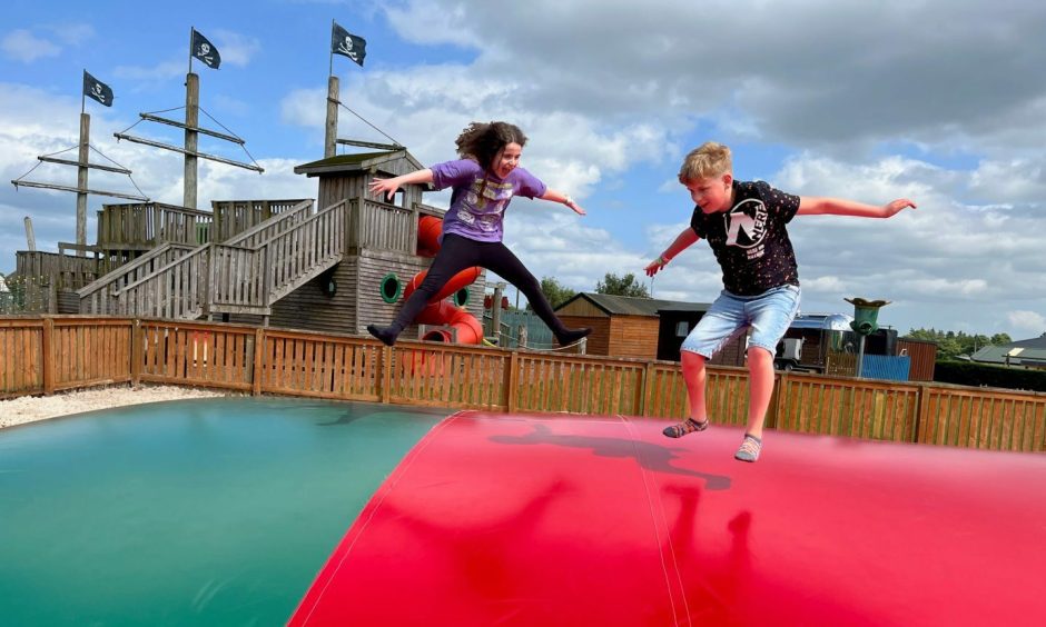 Alex and Edie Peebles on the jumping pillow at Active Kids Stanley adventure park.