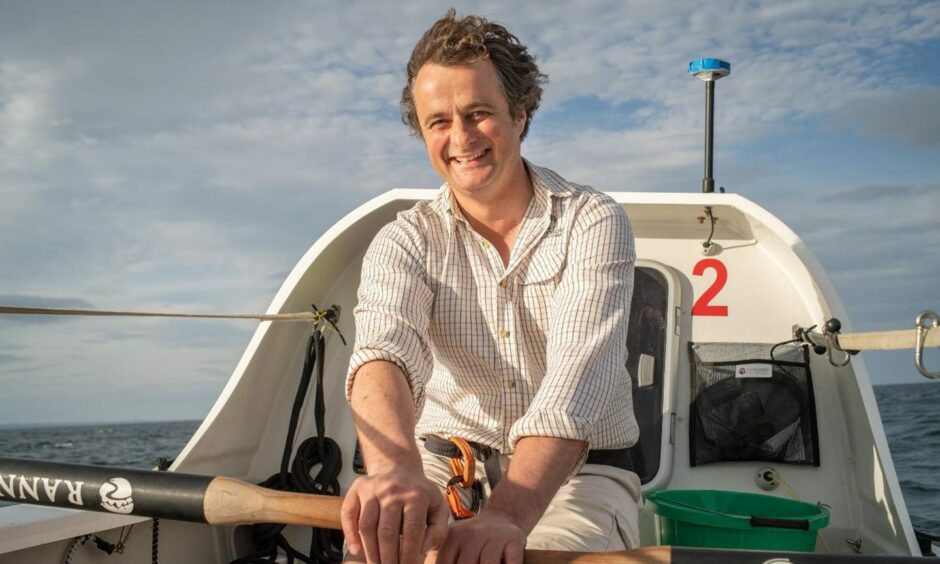 Henry Cheape on board his rowing boat.