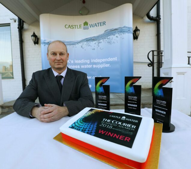 Castle Water CEO with Courier Business Awards winner cake.
