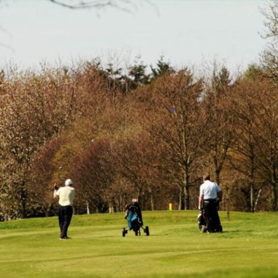 Two players on the fairway at Caird Park Golf Course.