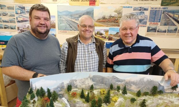 Club secretary Ryan Gray, club chairman Iain Smith and member Larry Beveridge of Cupar and District Model Railway Club, pictured with Larry's layout for 2023 'Parson's Creek'. Image: Michael Alexander