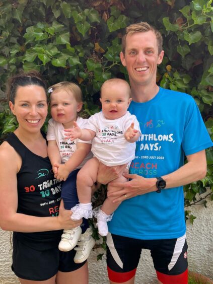 Charity triathlete Ryan Ramsay, pictured here with wife Katrina and daughters Amelia, 2 and Joanna Rose, 10 months, is raising funds for Arbroath charity Reach Across.