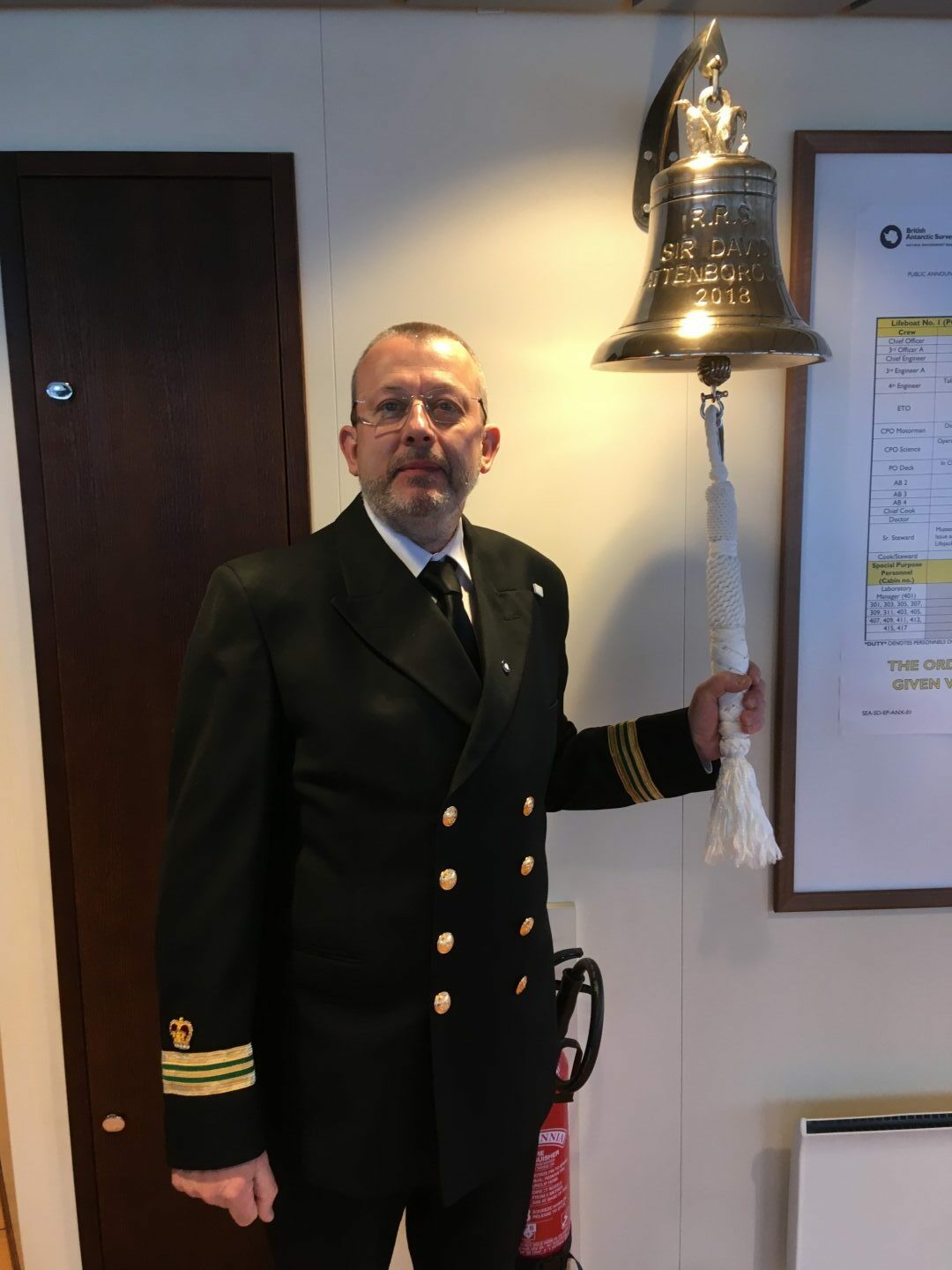 Mike Gloistein ringing the bell on the bridge of the RRS Sir David Attenborough. 