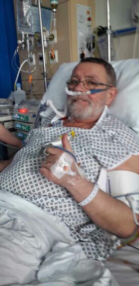 Iain Macleod pictured in hospital after having surgery to remove the tumour