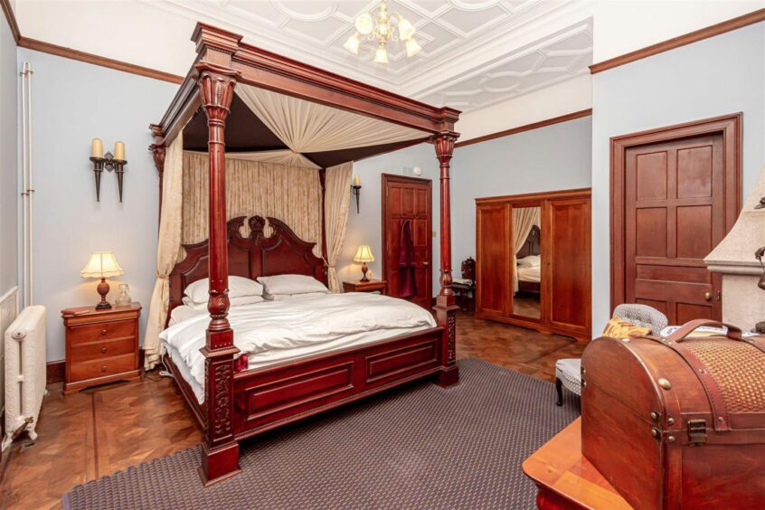 Four-poster bed in master bedroom at 2 Inzievar House 