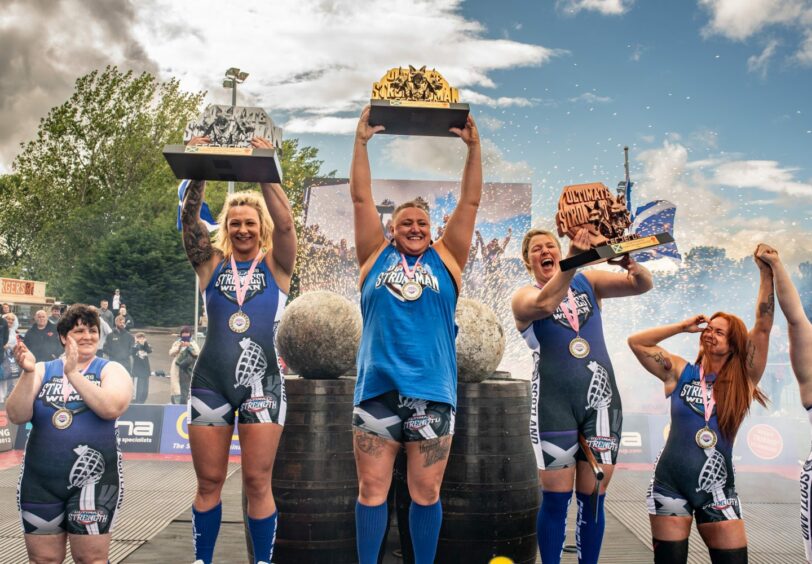 Izzy Tait from Dundee won Scotland's Strongest Woman competition. She is pictured with her trophy alongside the runners-up. Image: Bryan Robertson Photography.