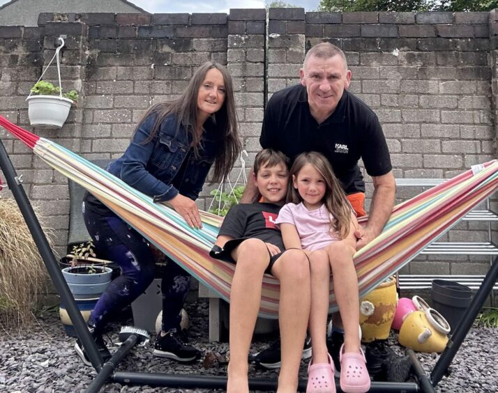 Janet Kerr with husband Gary and their grandchildren Lucas, 10, and Darci, 6.