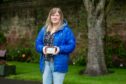 Rosie Gilbert-Virk with the photograph of her dad in the Springfield Park Rose Garden, Arbroath. Image: Kim Cessford/DC Thomson