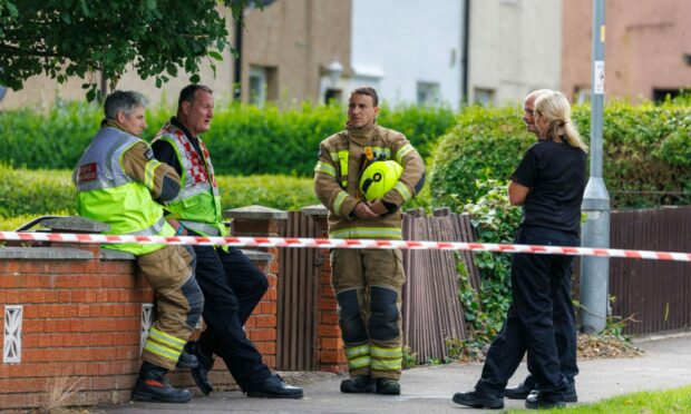 Fire and police officers after the Rosyth blaze was extinguished