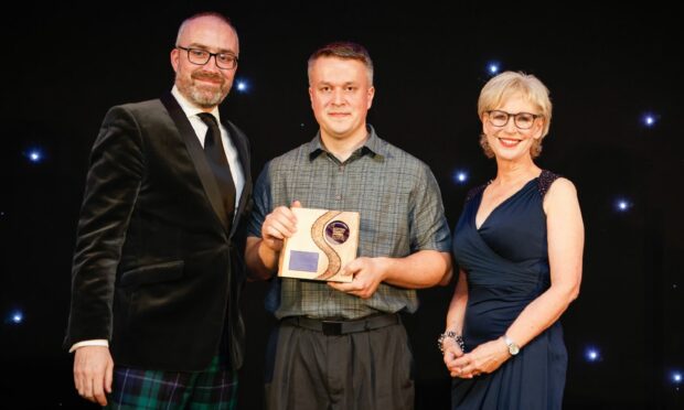 Andrii winning his award with Gordon Robertson (left) and Sally Magnusson (right). Photo: Lewis Houghton.