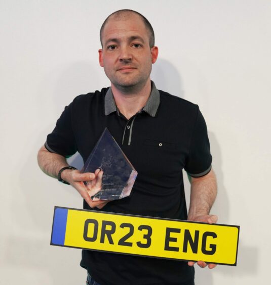 Lee with his trophy and new licence plate.