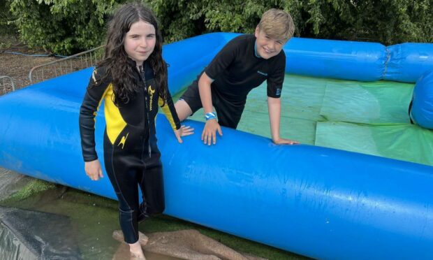 Alex and Edie on the waterslide at Muddy Boots Fife