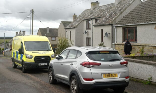 Police outside house in Keiss where man's body was found.