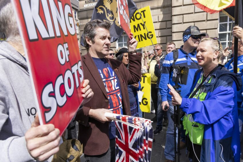 Protesters in Edinburgh, holding placards with slogans such as 'Not my king', on the Royal Mile ahead of the National Service of Thanksgiving and Dedication for King Charles III and Queen Camilla