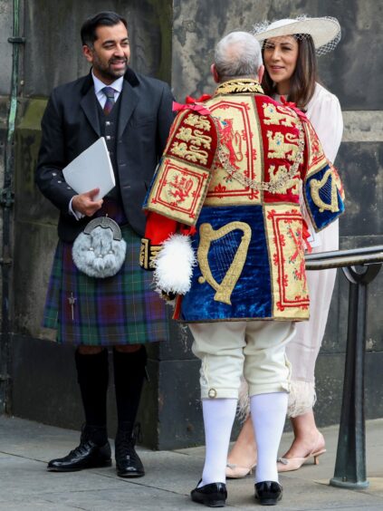 First Minister of Scotland Humza Yousaf, in kilt, and wife Nadia El-Nakla outside St Giles' Cathedral, Edinburgh, for the ceremony honouring King Charles III.