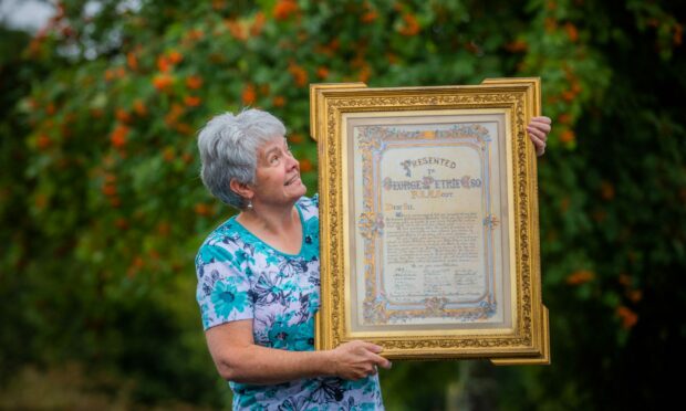 Hilary Farquharson with the gilt-framed Petrie piece. Image: Steve MacDougall/DC Thomson