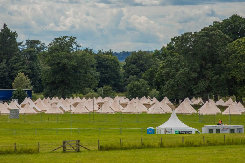 glamping site for rewind festival at Scone palace showing rows and rows of cream coloured tepees.