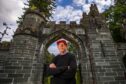 Tom Collopy, Discovery Land Company's chief project officer at Taymouth Castle, standing in front of the imposing stone gates.