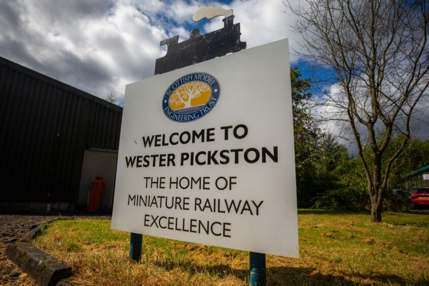 Sign saying 'Welcome to Wester Pickston: The home of miniature railway excellence'.