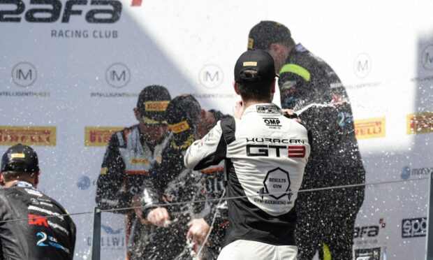 Sandy Mitchell soaks rival Jonny Adam in the Portimao podium celebration. Image: McMedia