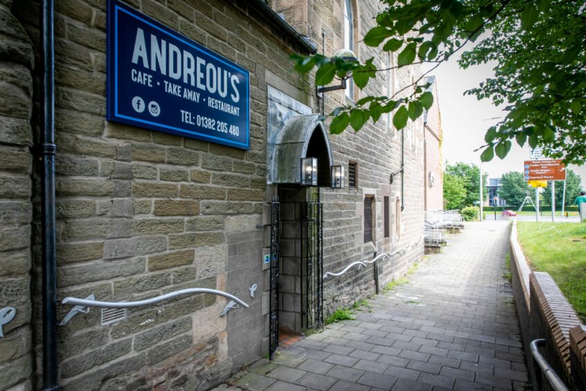 A sign for Andreou's Dundee on the side of Meadowside St Paul's Church.
