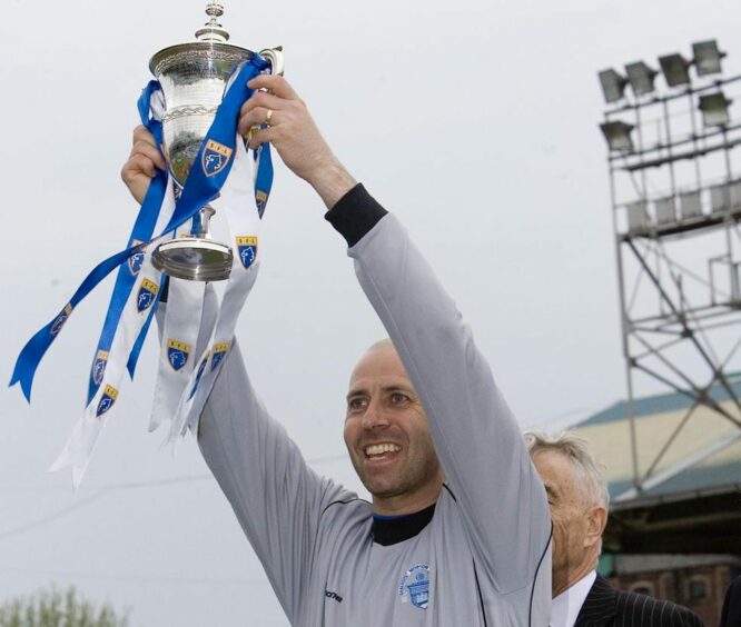 Paul Mathers lifting the Division Two title with Morton