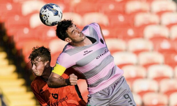 Dundee United's Ollie Denham is beaten in the air by Brian Graham of Partick Thistle