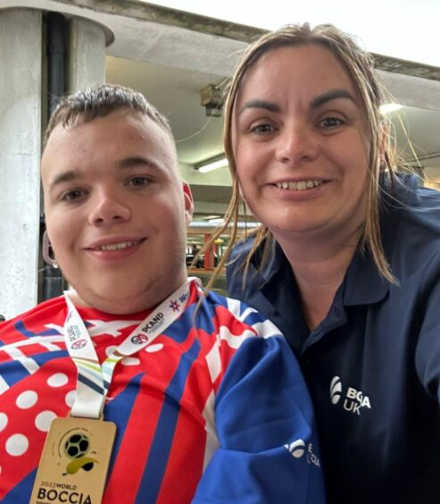 Tyler McLelland shows off boccia gold medal with his mum Emma in Portugal.