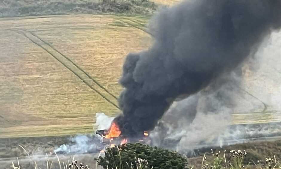 Black smoke and flames coming from a combine harvester on the A92 near Inverkeilor