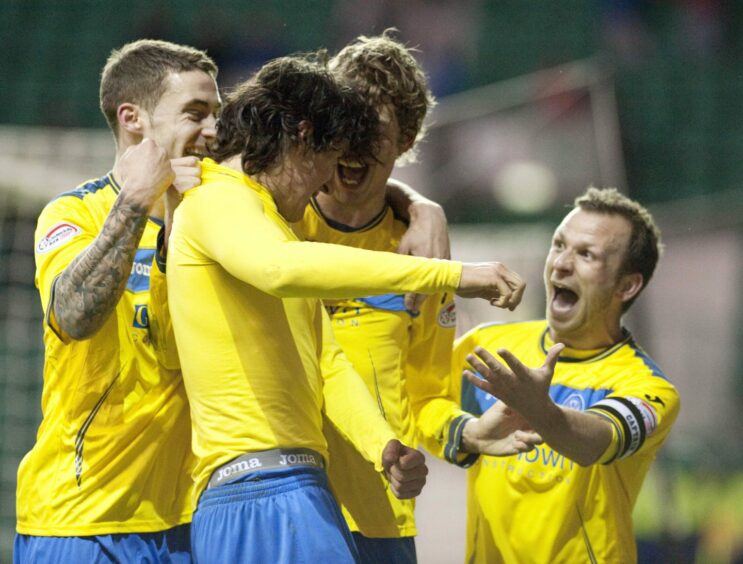 Fran Sandaza is mobbed after netting a St Johnstone winner at Easter Road in 2012. 