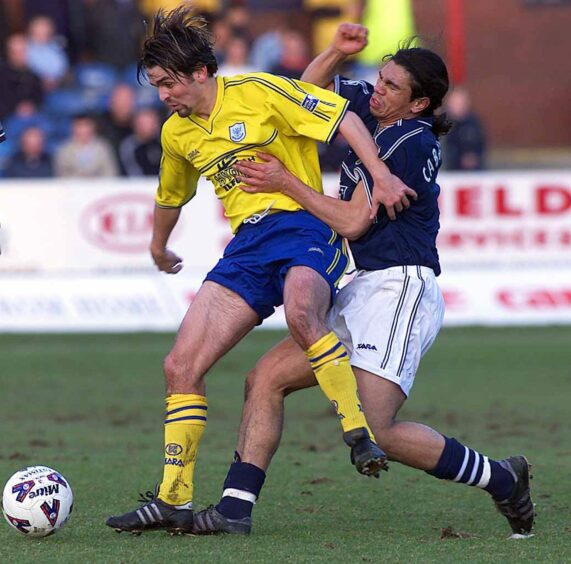Paul Hartley holds off Fabian Caballero at Dens Park in 2002.