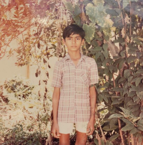 Jagadeesh in front of trees in India.