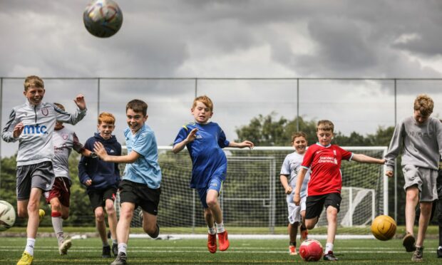 Spot the Ball. Youngsters try out the Skilz Academy community astro pitch. Image: Mhairi Edwards/DC Thomson