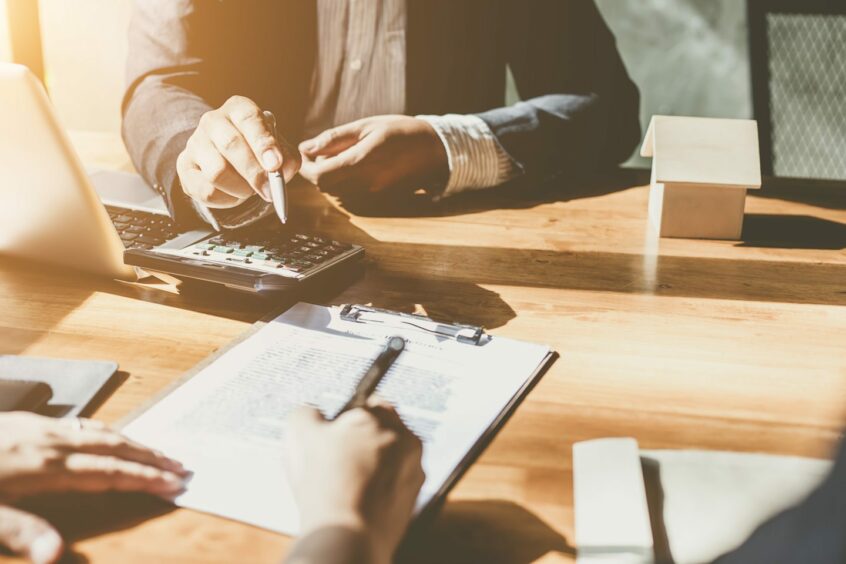 Business person signing a contract.