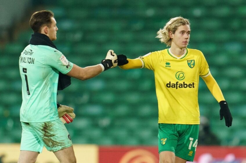 Jack Walton bumps fists with current Rangers midfielder Todd Cantwell, then of Norwich
