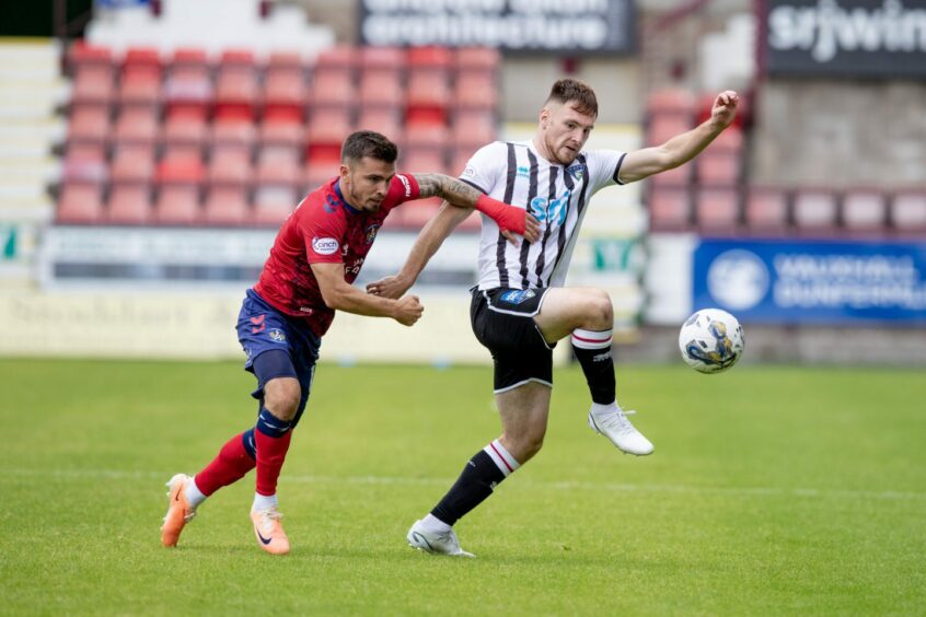 Dunfermline Athletic FC defender Josh Edwards holds off the attentions of Kilmarnock winger Danny Armstrong.