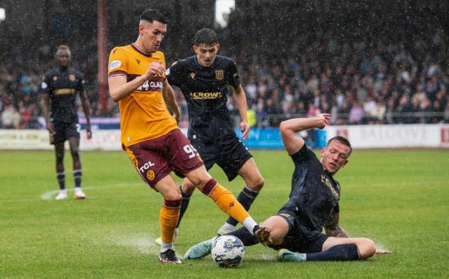 Lee Ashcroft slides in on Connor Wilkinson. Image: SNS