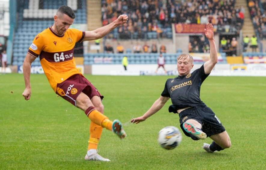 Lyall Cameron closes down Paul McGinn as Dundee drew with Motherwell. Image: SNS.