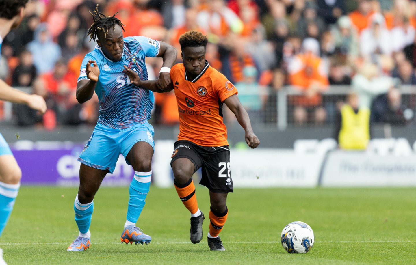 Mathew Cudjoe of Dundee United holds off Ewan Otoo of Dunfermline.