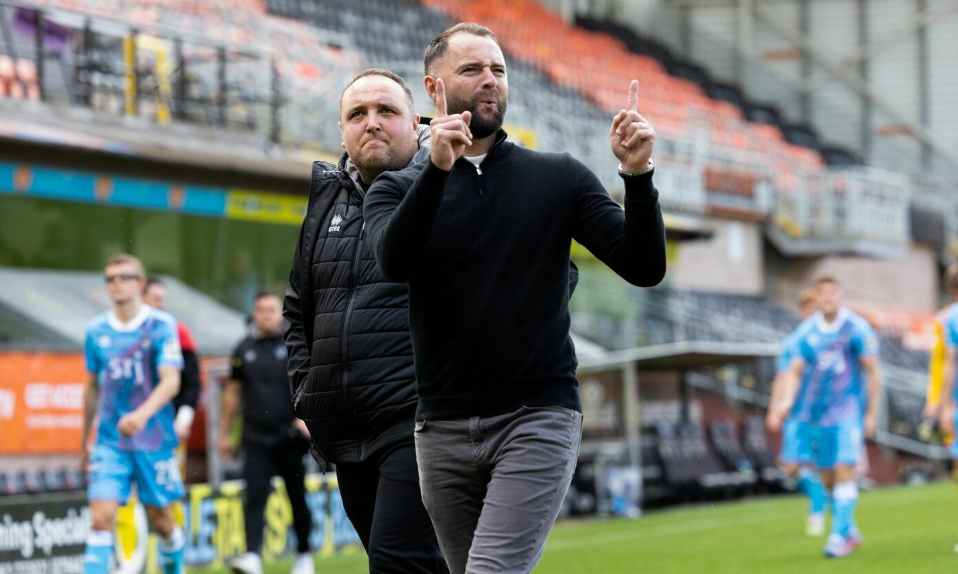 Dunfermline Athletic manager James McPake makes a "1-1" gesture to Dundee United fans