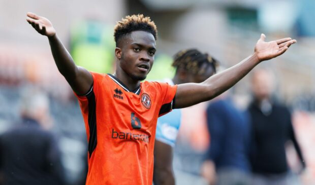 Mathew Cudjoe takes the acclaim of fans at Tannadice.