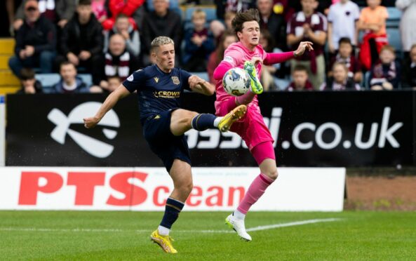 Luke McCowan and Alex Lowry go for the ball as Dundee hosted Hearts. Image: SNS