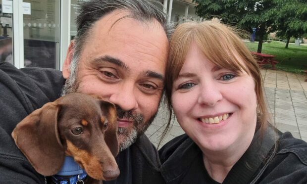 Maverick the dog who has diabetes - pictured with Dundee owners Andy and Karen Marr.