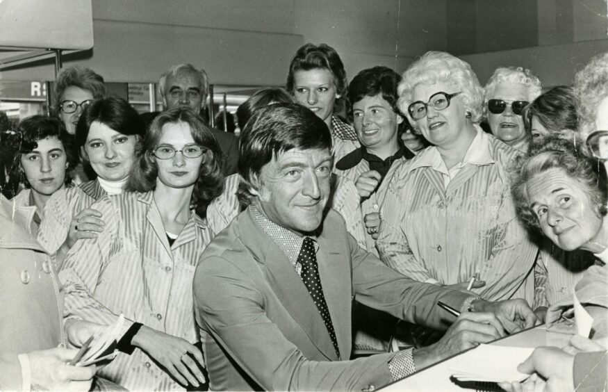 Michael Parkinson signs autographs when he opens Kirkcaldy's Co-op in June 1978. Image: DC Thomson.