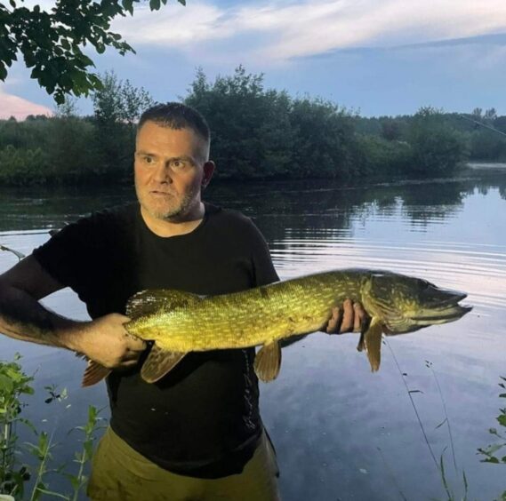 Allan Steele holding a big fish